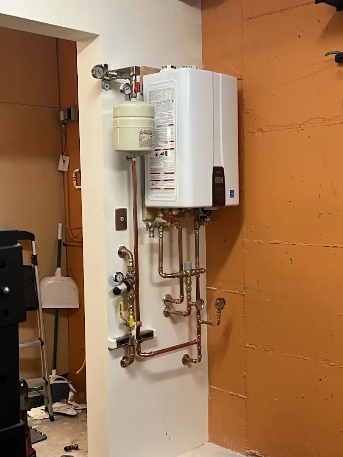 Plumbing technician inspecting water heater connections in Lake San Marcos